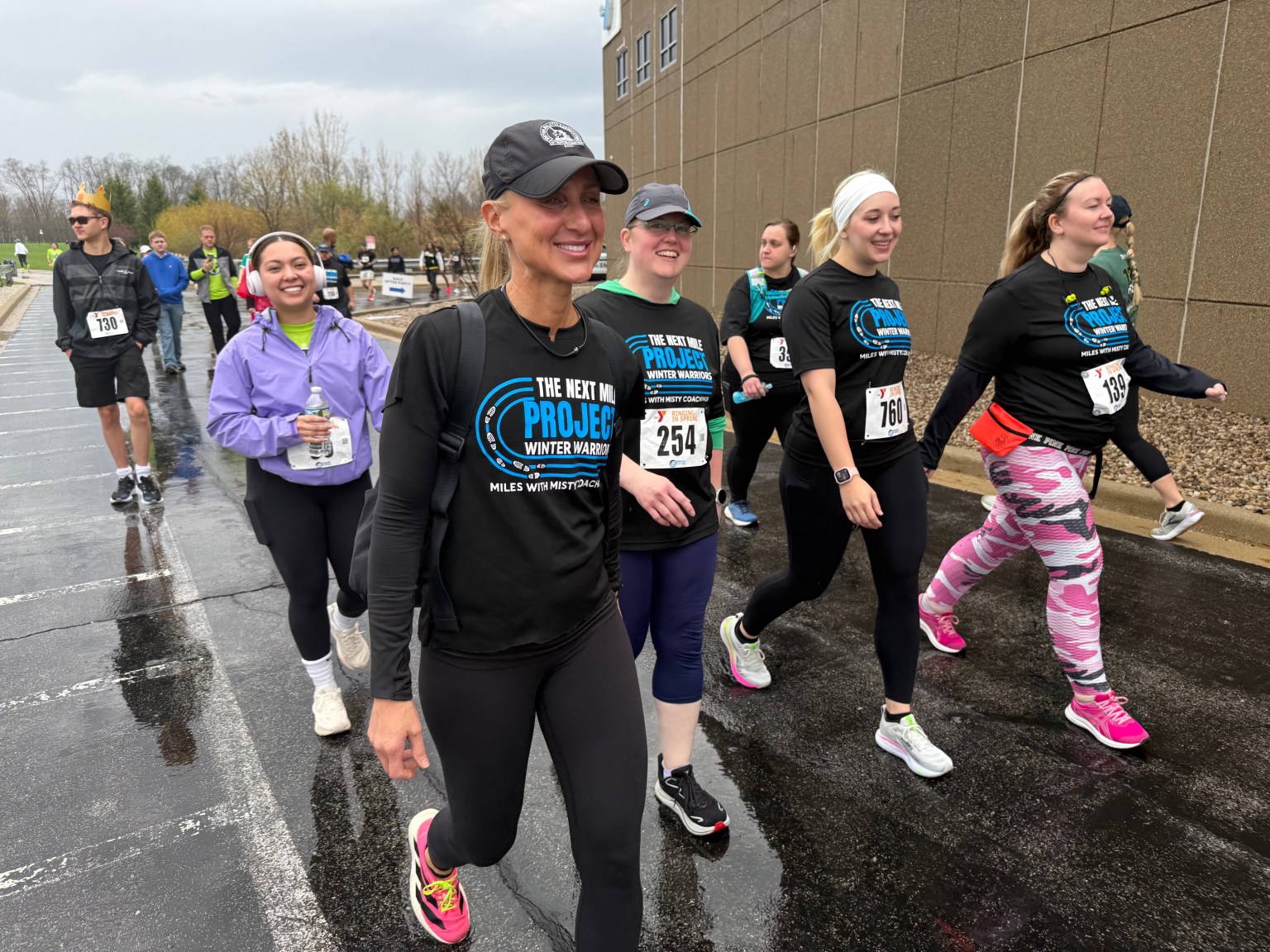 Coach Misty walking with a group of beginner runners after a race