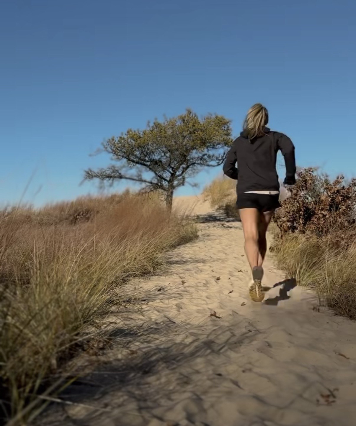 Coach Misty, an online running and strength coach in Northwest Indiana, leading runners of all levels during an outdoor workout.