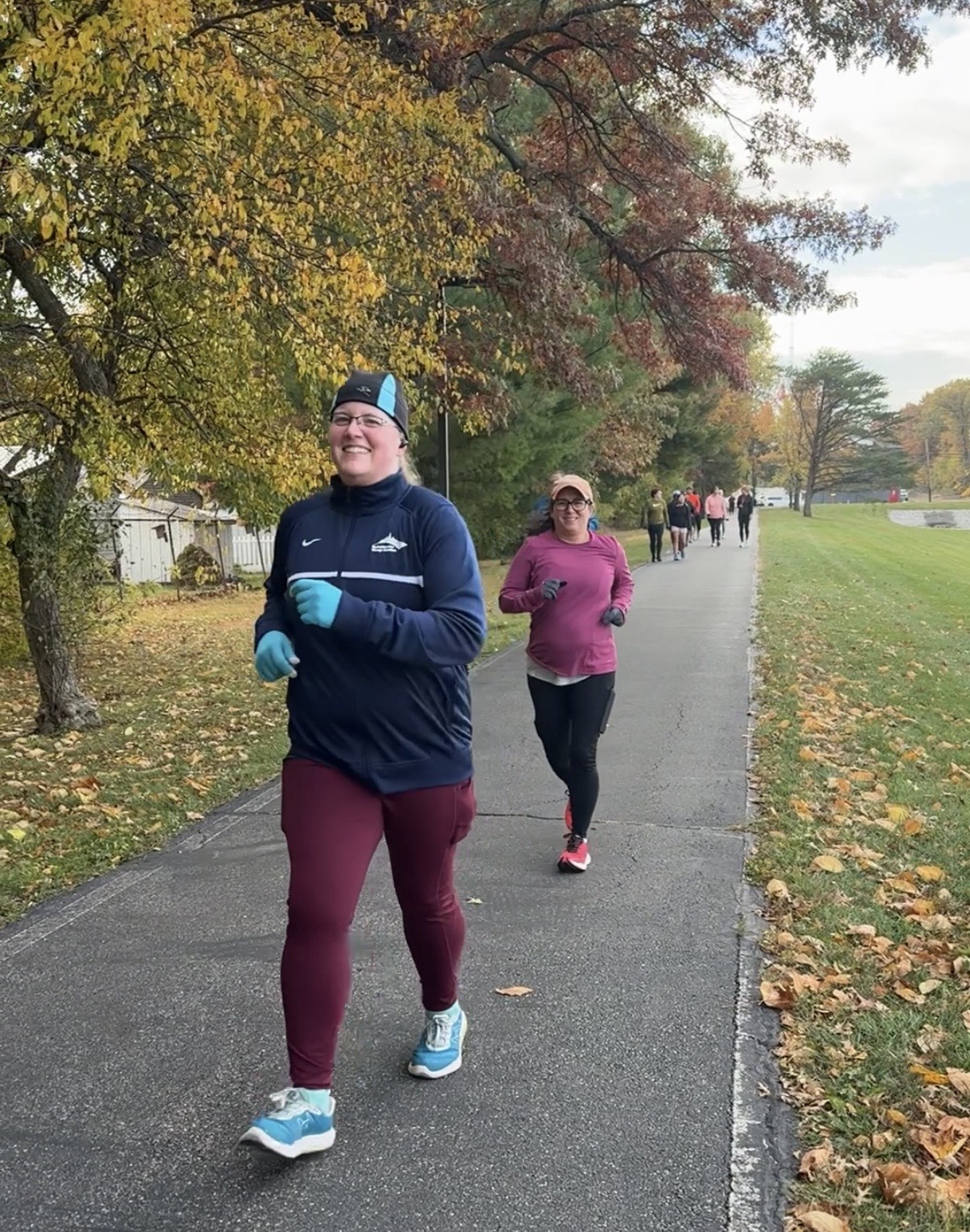 Coach Misty, an online running and strength coach in Northwest Indiana, leading runners of all levels during an outdoor workout.